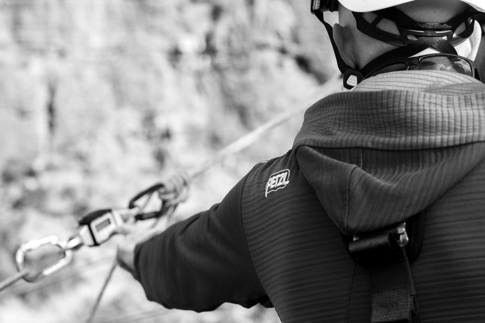 Rope access technician training against a rock face